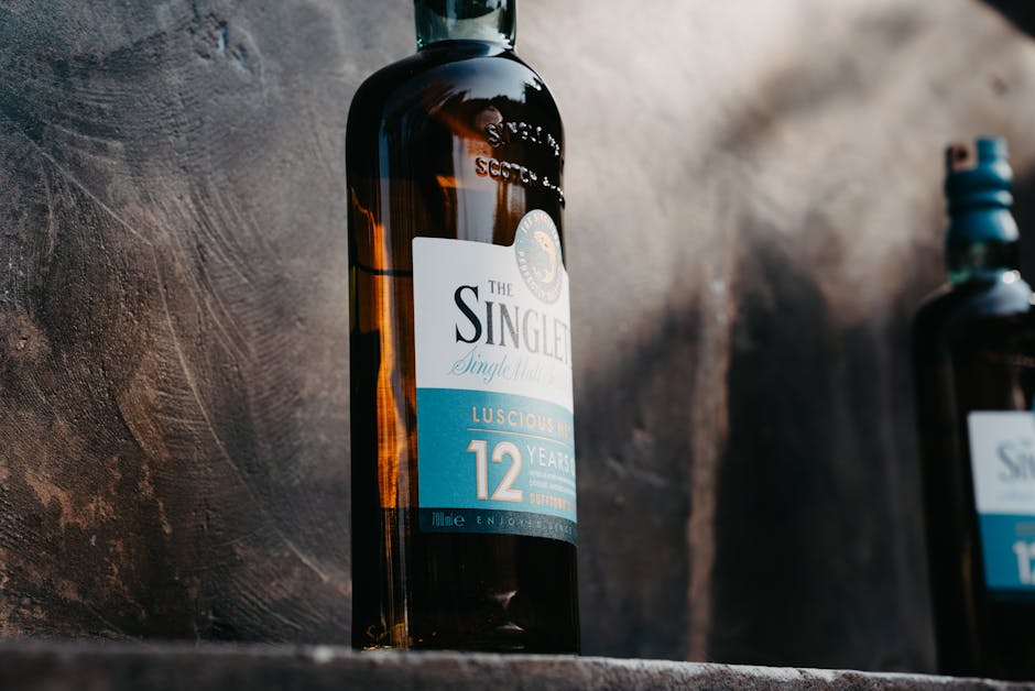 single malt whisky bottles lineup, whisky tasting glass amber