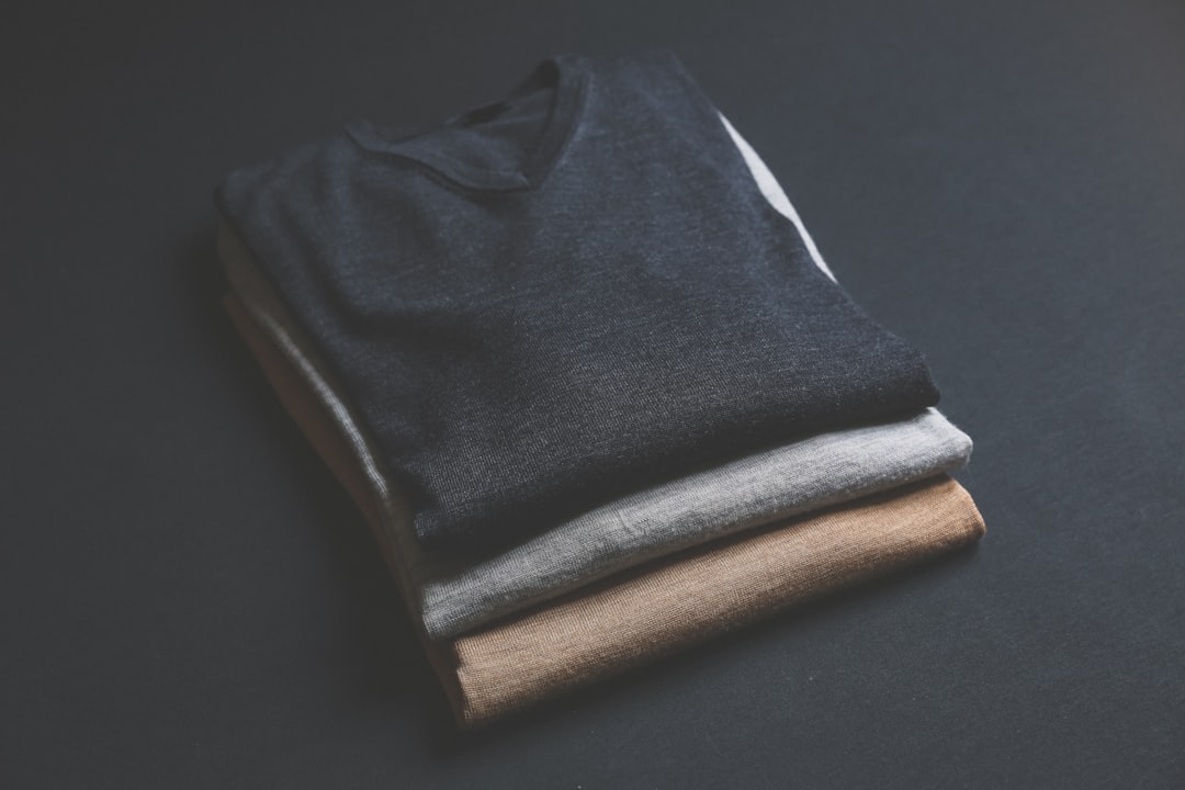 minimalist wardrobe flat lay, neutral clothing folded neatly