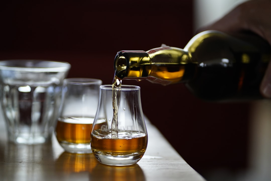 single malt whisky bottles lineup, scotch whisky tasting glass amber